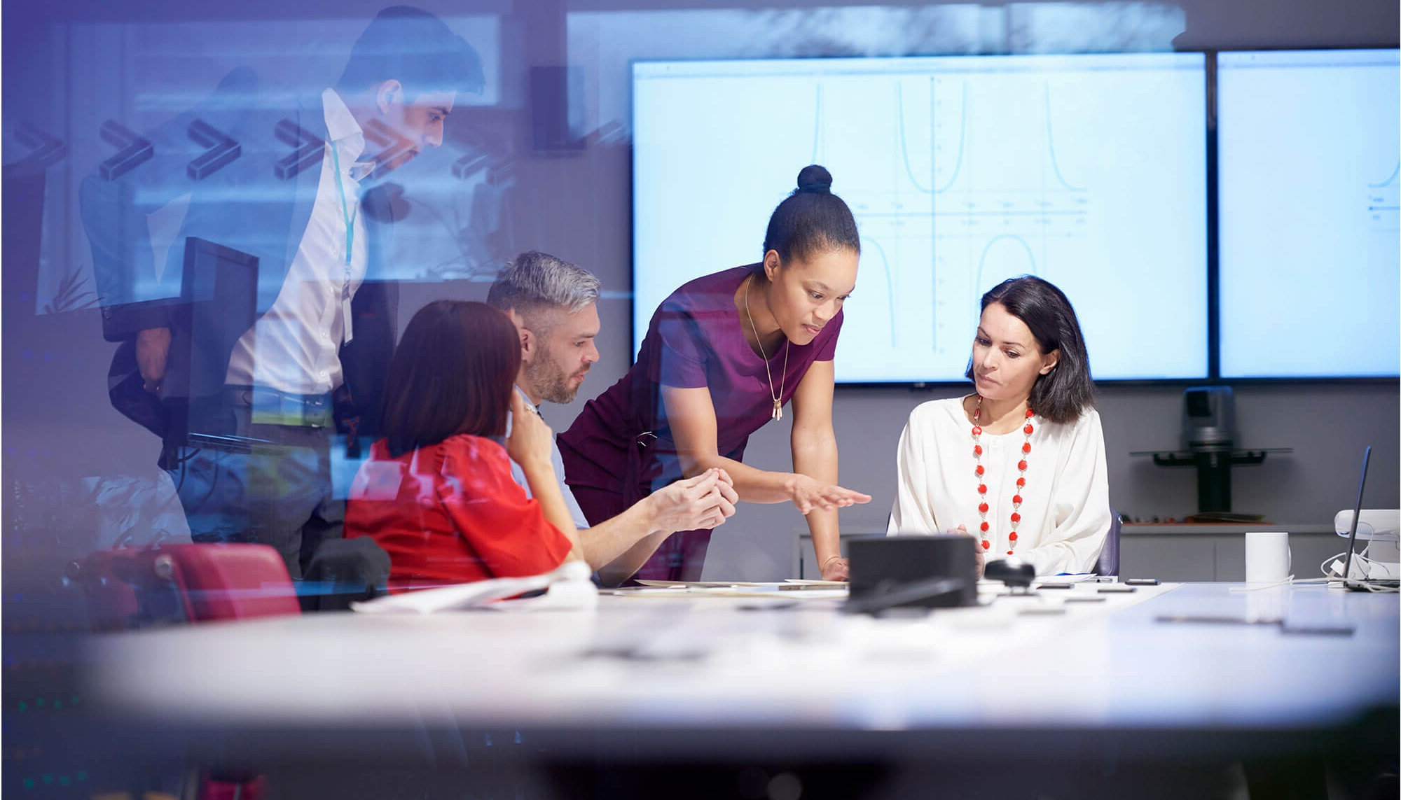 Senior technology leader advising a business team in a modern boardroom