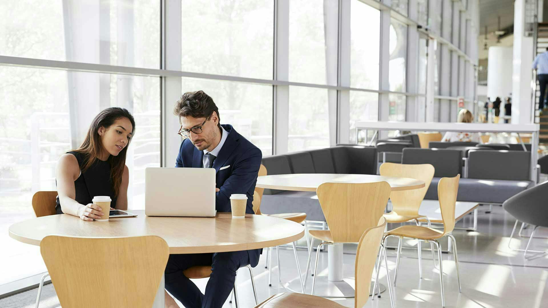 Business professionals reviewing technology infrastructure and systems in a modern office